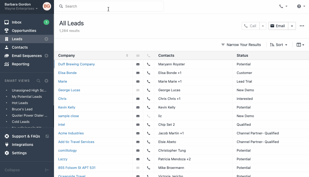 CRM leads list showing sidebar smart views and main table of companies, contacts, and status.